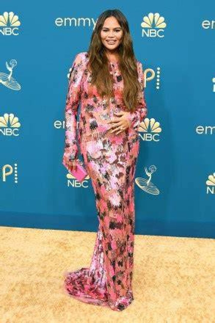 Chrissy Teigen Reveals She Still Has A ‘Bump’ While Rocking Cutout Dress 2 Mos. After Losing Baby