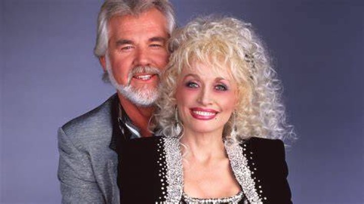 Dolly Parton Mourns Friend Kenny Rogers: ‘He’ll Be Asking God To Spread Some Light On This Darkness’