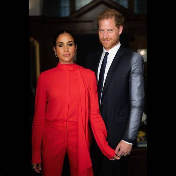 Meghan Markle & Prince Harry Smile Mysteriously, Hold Hands In New Photos From Recent U.K. Visit